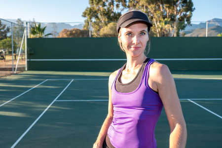 female tennis player standing at the net of the courtの写真素材