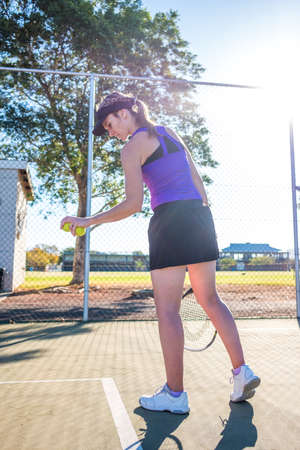 female tennis player serving during a tennis matchの写真素材