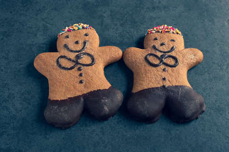 two ginger bread men on a dark slate backgroundの写真素材