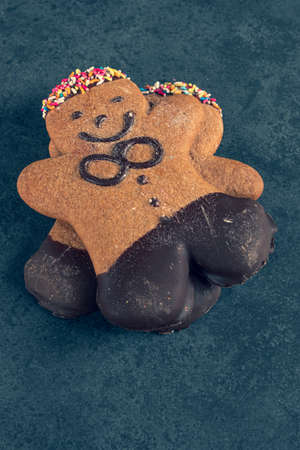 two ginger bread men on a dark slate background