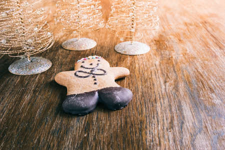 ginger bread man with christmas decorations on a wooden tableの写真素材