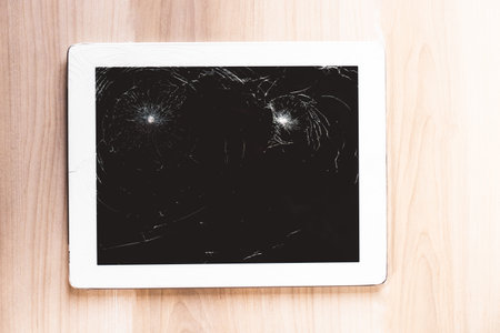 close up image of a smashed screen on a tabletの写真素材