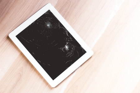 close up image of a smashed screen on a tabletの写真素材