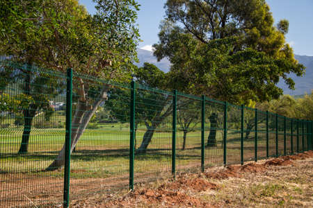 newly installed mesh fence protecting a golf courseの写真素材