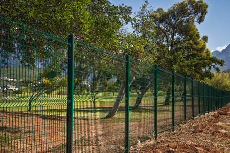 newly installed mesh fence protecting a golf courseの写真素材