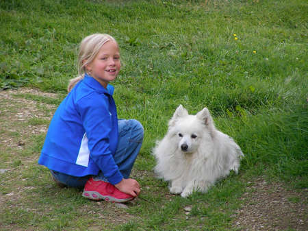 Girl and white dogの写真素材