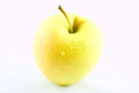 Delicious and fresh yellow apple isolated on a white backgroundの写真素材