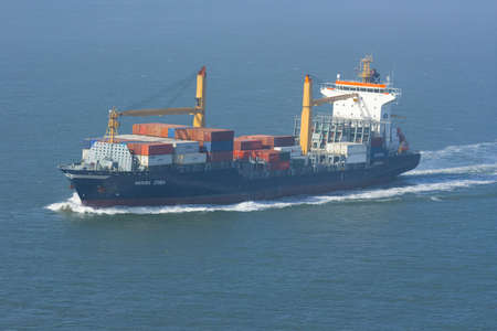 Containership with containers leaving the harborの写真素材