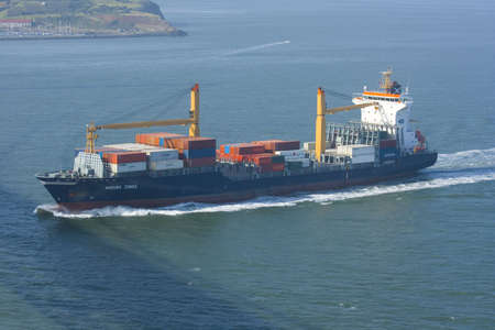 Containership with containers leaving the harborの写真素材
