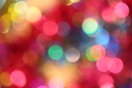 Colored blur defocused background with bokeh effect. Red-pink tone