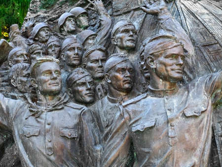 Bas-relief, depicting faces of triumphant soldiers at moment of announcement of German surrender,...