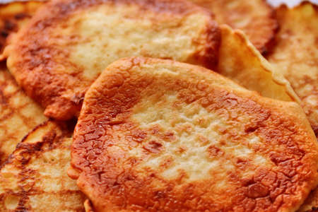 Small pancakes closeup on a white plate. Wide pancake week. Shallow depth of field