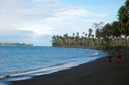 People walk at ocean beach, Papua New Guineaのeditorial素材