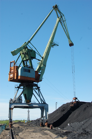 River port cargo crane loading coal, Kolyma river, Russiaの写真素材