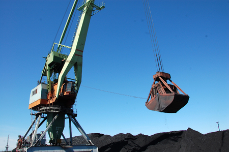 Dockside cargo crane loading coal at Kolyma river port, Zyryanka, Yakutia, Russiaの写真素材