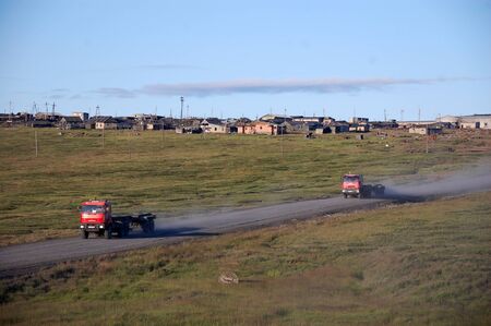 Trucks at gravel road abandoned town Chukotka, Russiaの写真素材