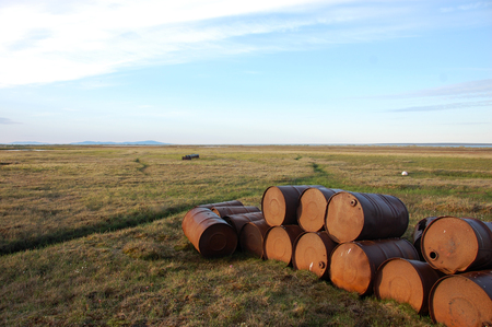 Abandoned oil drums at tundra, Chenkul Island, Chukotka, Russiaの写真素材