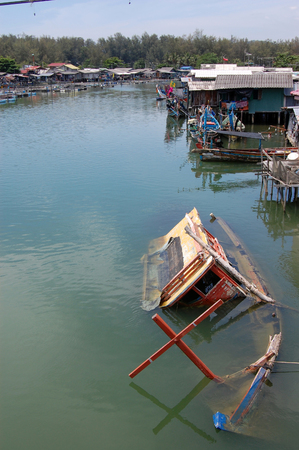 Abandoned sinked boat at river, Southern Thailandの写真素材