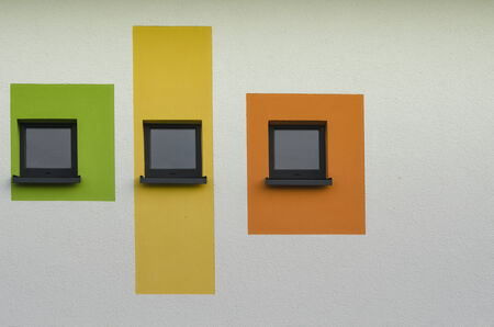 Colourful windows on a white wallの写真素材
