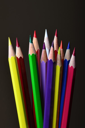 An image of multi-coloured pencils on a black backgroundの写真素材