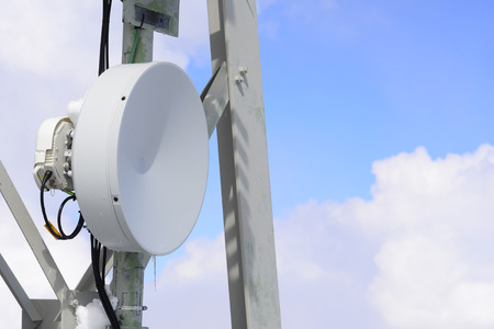 Close up of a satellite communications dish high in the clouds