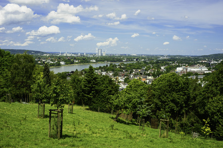 A landscape image from high on a hill with the German city Bonn faraway in the distanceの写真素材