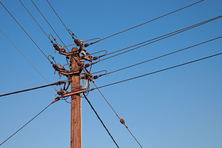 Close up image of a telegraph pole in the setting sun with vibrant coloursの写真素材