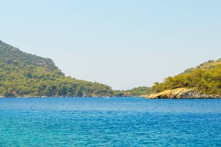 Image of deep blue sea with mountains and skyの写真素材