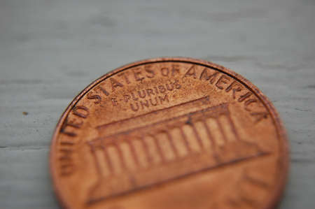 A closeup shot of a one euro coin on a wooden surfaceの写真素材