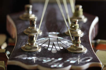 Close up of the fretboard of an acoustic guitar, shallow depth of field