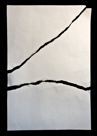 White broken paper in black backgroundの写真素材