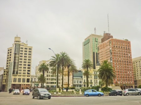 A bunch of buildings and palm trees and cars of Montevideo independence square in Uruguay, South Americaのeditorial素材