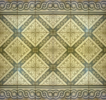 Real floor decorative mosaic with flower and ornament motif in yellow and pale brown tones useful as...