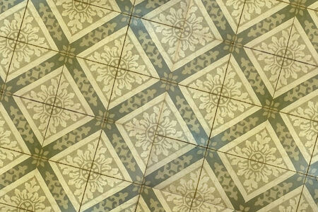 Real floor decorative mosaic with flower and ornament motif in yellow and pale brown tones useful as...