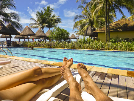 Body part of a couple enjoying a spectacular summer day in a swimming pool of a spa in brazil, south america.のeditorial素材