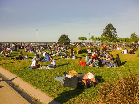 ROSARIO, ARGENTINA JULY 2014 - Crowd of people of different ages enjoying a beautiful sunny sunday day at park in front of the "Paraná" river in the city of "Rosario" in Argentinaのeditorial素材