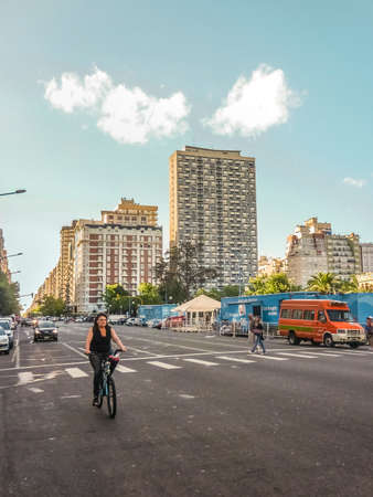 MAR DEL PLATA, ARGENTINA - JANUARY 2014 - Woman on bicycle in the avenue of Mar del Plata city, the most famous seaside resort of Argentina South Americaのeditorial素材