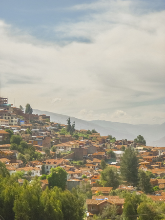 Famous colonial historic cusco city houses in the highs of a mountain.の写真素材