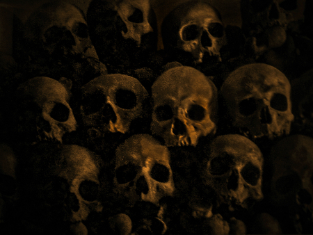 Real stacked skulls in orange and black tonesの写真素材