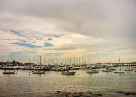Group of many yachts and boats in a beautiful cloudy and tranquil day at the port in Punta del Este, the most famous seaside resort of Uruguayのeditorial素材