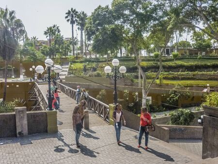 LIMA, PERU, APRIL 2014 - Group of tourists crossing the Puente de los Suspiros in barranco district in the city of Lima in Peru.のeditorial素材