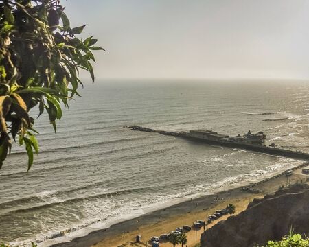 Aerial view of the city of Lima at daytime with the pacific ocean as the main subject.の写真素材