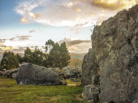 Nice landscape view with foreground big rocks and mountains at background in sacsayhuaman fortress in the ancient city of Cuzco in Peru.の写真素材