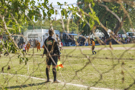 MONTEVIDEO, URUGUAY, MARCH - Spectator view photo of soccer match between two children teams in a sunny day in Montevideo, the capital of Uruguay in South America.のeditorial素材