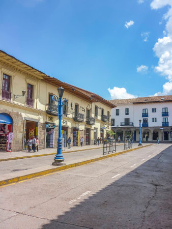 Perspective urban view of the street at sunny day with people walking in the city of Cusco in Peru,...