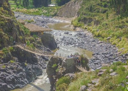 High angle view photo of a group of tourist crossing a bridge in Colca valley in the outsides of Arequipa city in Peru.の写真素材