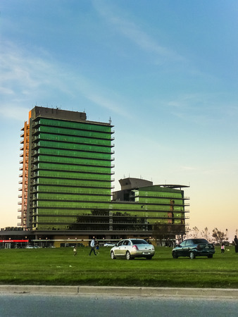 Modern skycrappers and people with his cars in the park surrounded located in the city of Rosario in Argentina.のeditorial素材