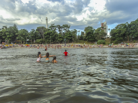 CANELONES, URUGUAY, FEBRAURY - 2015 - Children playing in the water at the beach of Atlantida, one of the most famous watering places of Uruguay in South Americaのeditorial素材