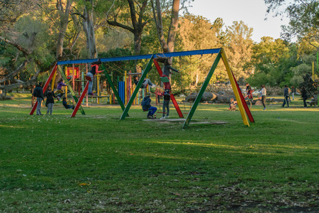 MONTEVIDEO, URUGUAY, MAY - 2015 - Children having a good time playing children games in a sunny day at park in the city of Montevideo, Uruguay.のeditorial素材