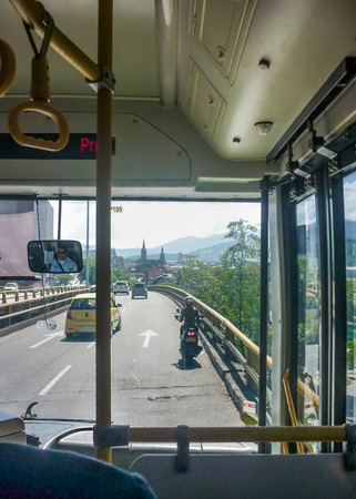 MEDELLIN, COLOMBIA, DECEMBER - 2014 - Inside bus view of avenue street in Medellin, one of the most important cities of Colombia.のeditorial素材